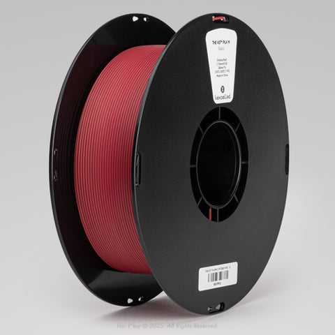Reel of matte Chelsea Red PLA 3D printing filament on a black plastic spool, shown from a three-quarter front view angle with a light grey background.