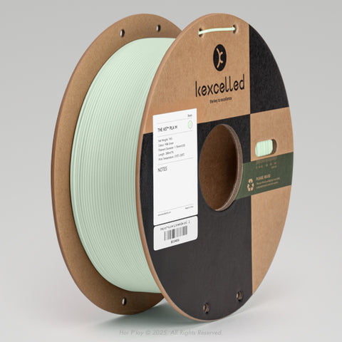 Reel of matte milk green PLA 3D printing filament on a recycled cardboard spool, shown from a three-quarter front view angle with a light grey background.